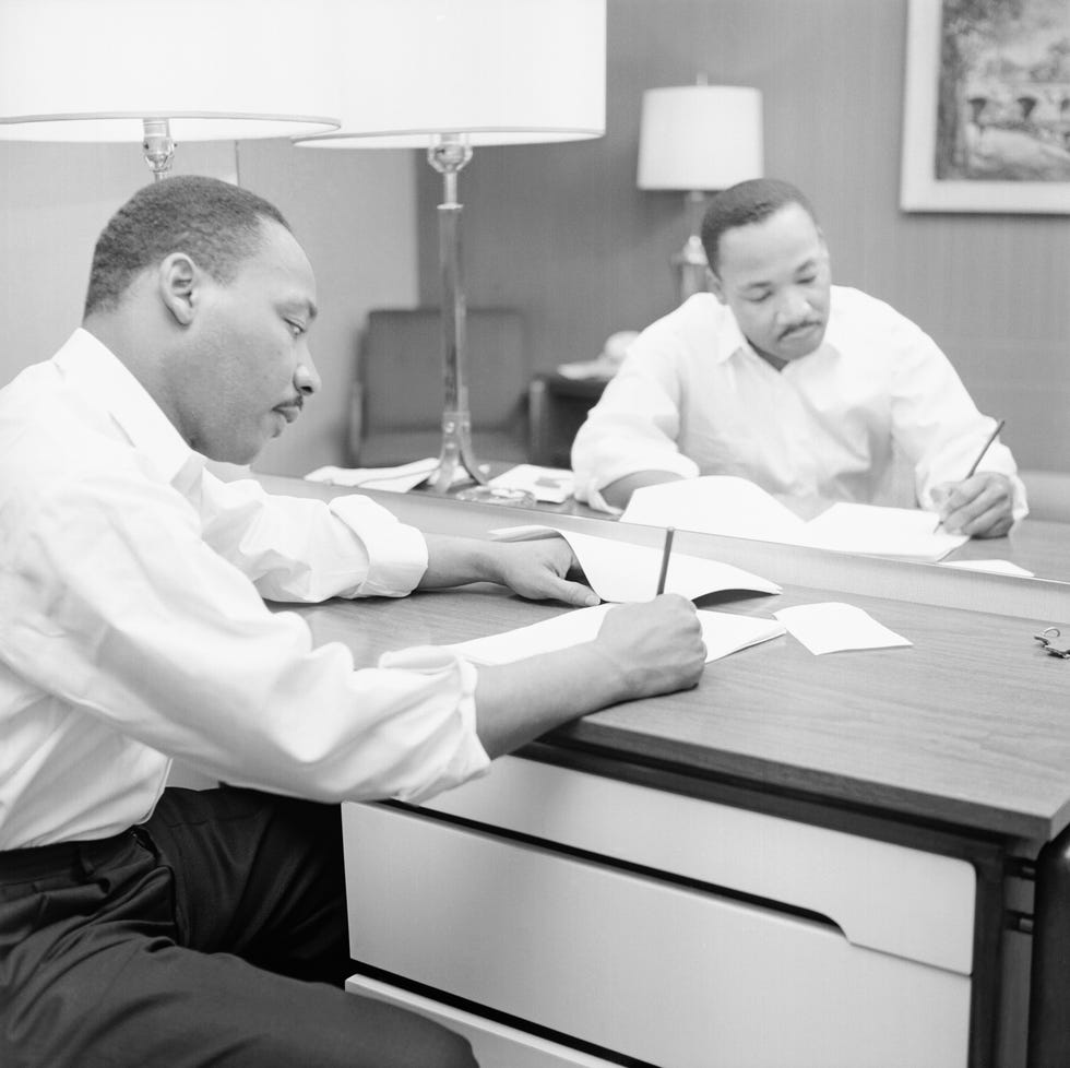 martin luther king sitting at a hotel desk