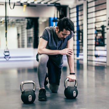 japanese man works out with dumbells