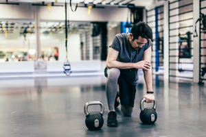 japanese man works out with dumbells