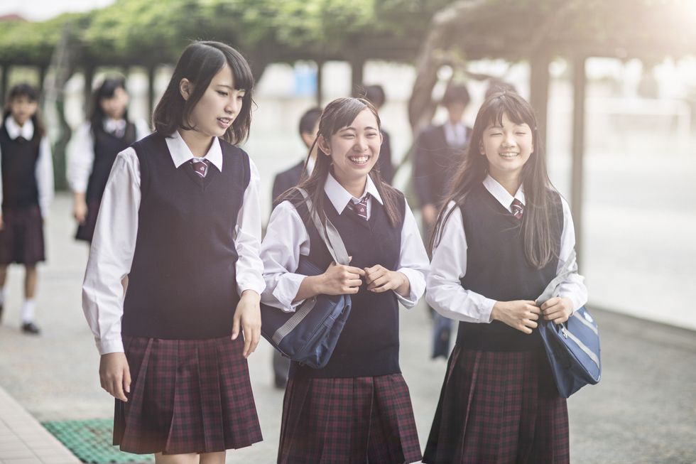 japanese students walking outside the school yard