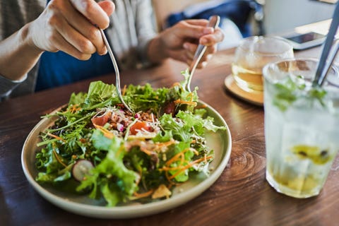 Japanese woman eating a vegan lunch at a vegan cafe japanese woman eating a vegan lunch at a vegan cafe