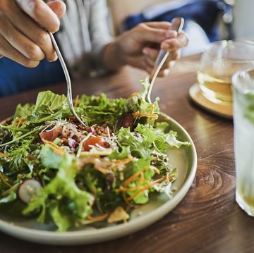 woman eating a vegan lunch at a vegan cafe