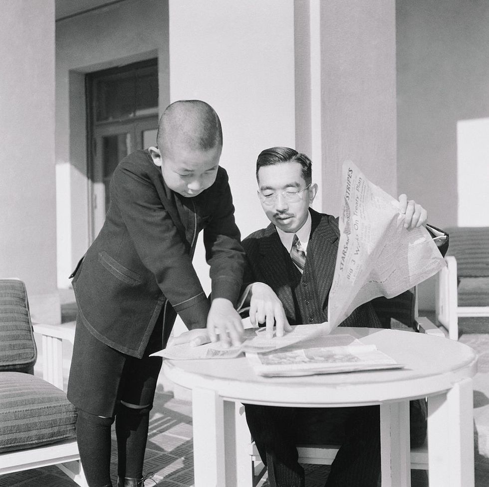 emperor hirohito and prince akihito reading a newspaper