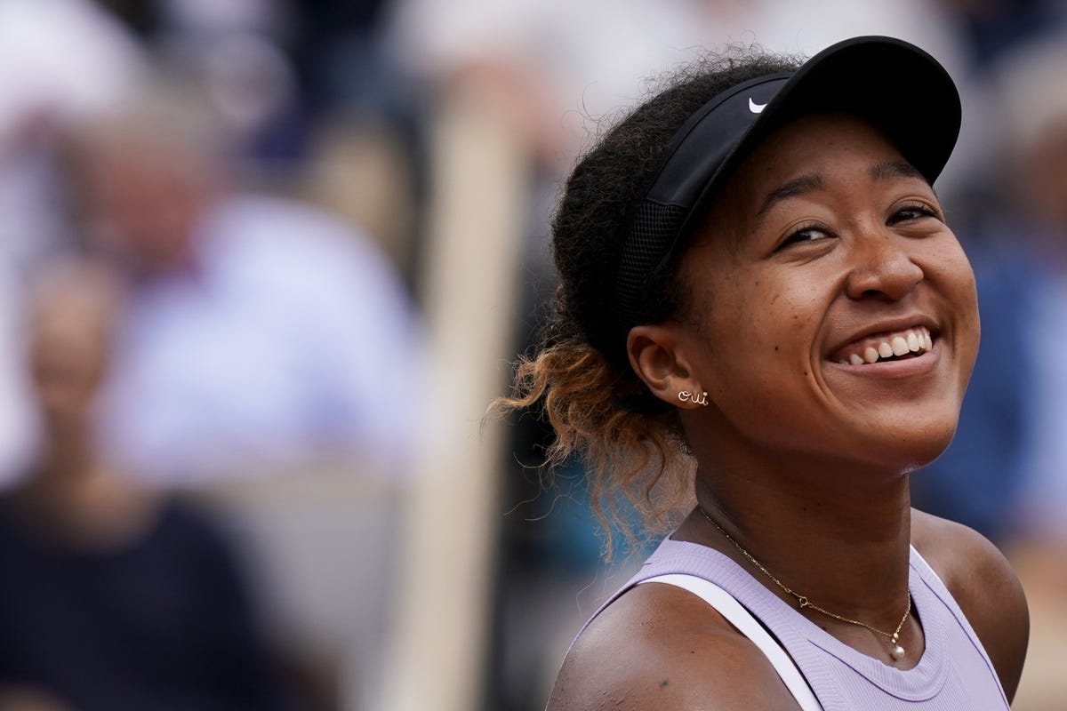 Naomi Osaka is all smiles as she strikes a pose during a photoshoot -  Photogallery