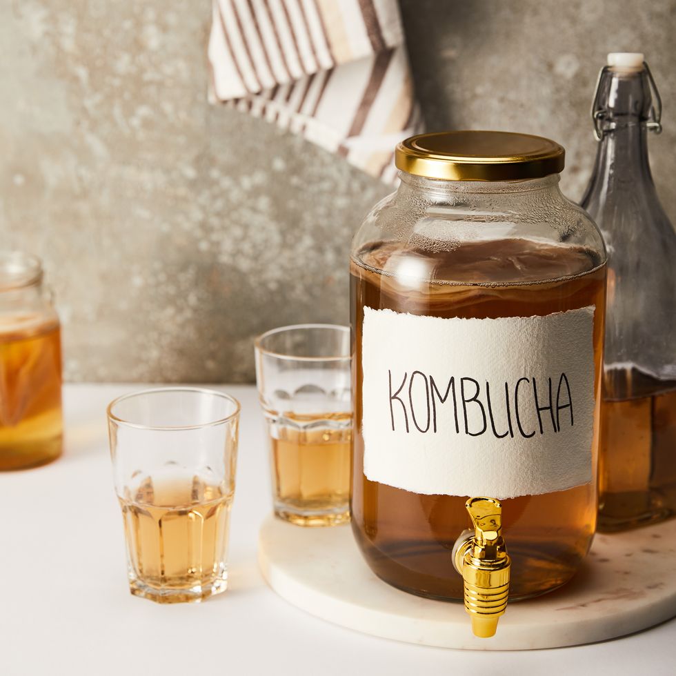 jar kombucha glasses textured grey,closeup of herbal tea in glass on table