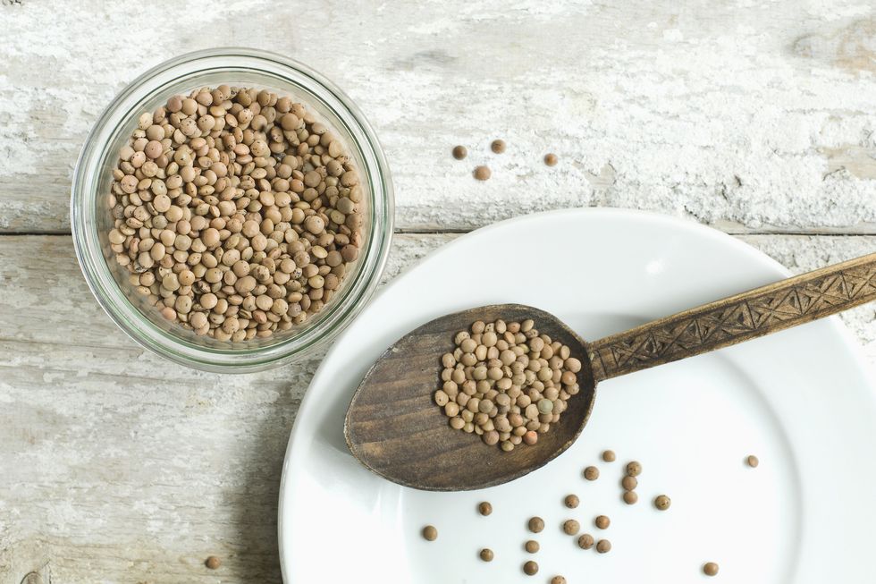 jar of mountain lentils on wooden table seen from above