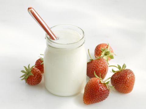 Jar of yoghurt and fresh strawberries
