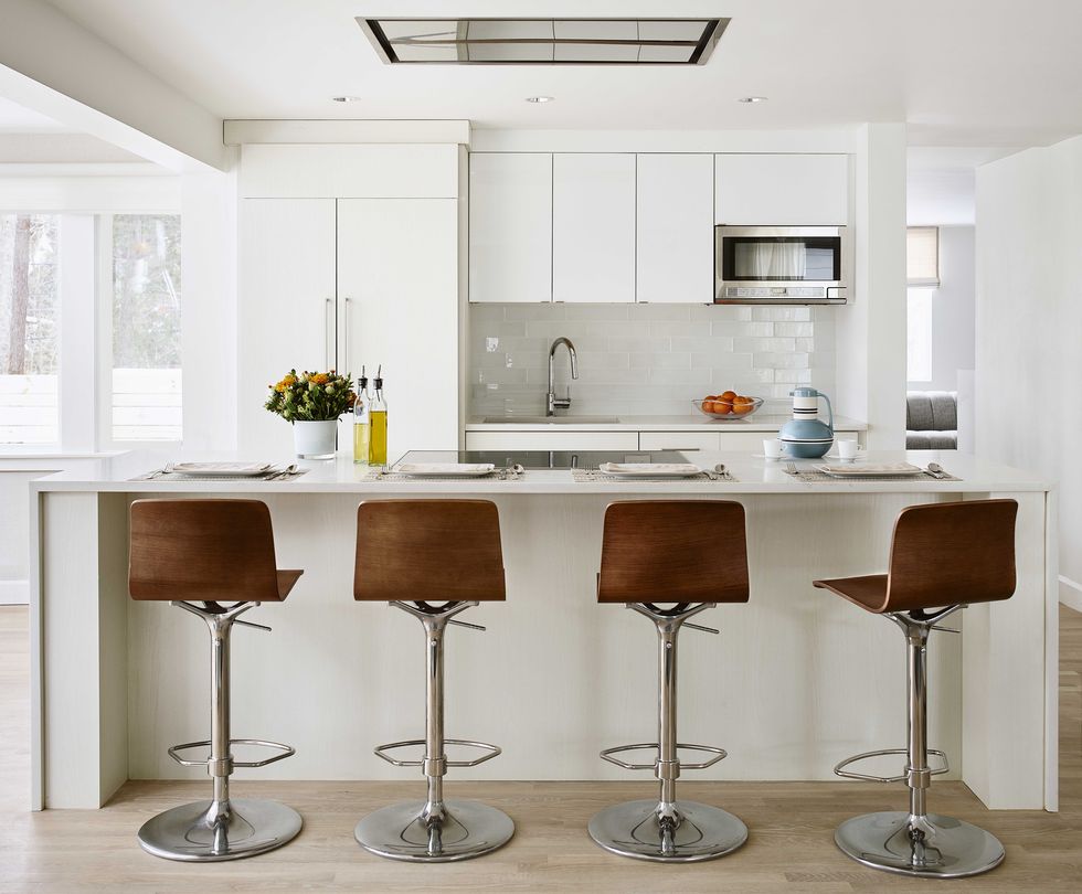 white kitchen cabinets, brown leather bar stools