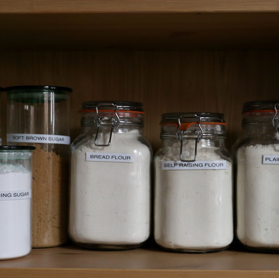 jars of flour and sugar on a wooden shelf