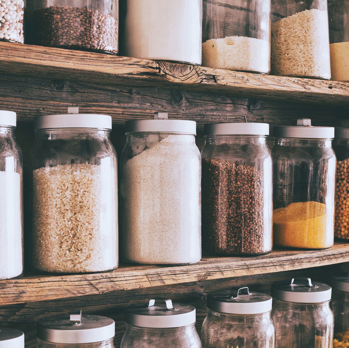 jars of ingredients on wooden shelves in pantry