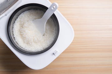 jasmine rice cooking in electric rice cooker with steamcooking rice in a japanese pot, a traditional recipe,copy space for text