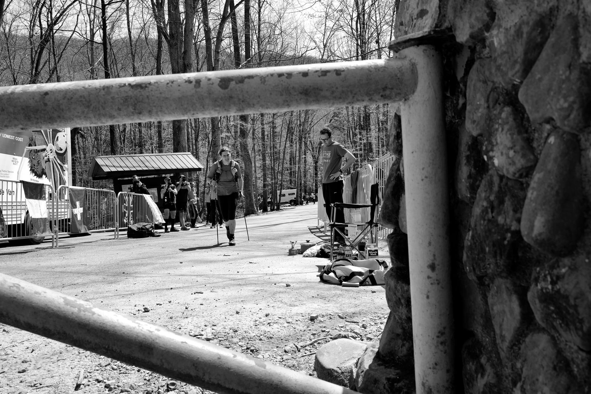 a woman runs towards a gate
