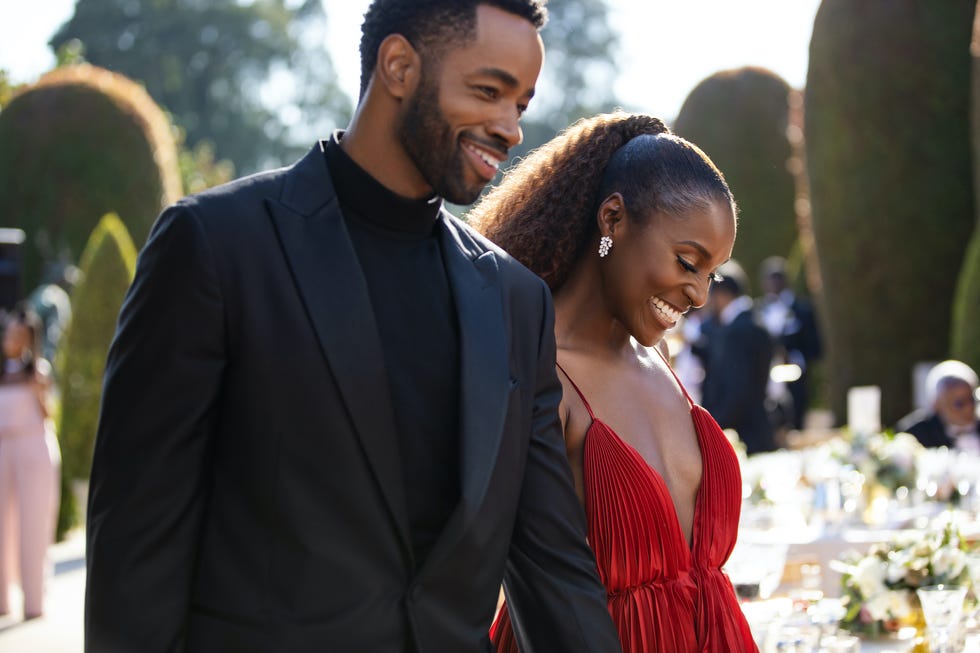 a couple dressed elegantly walking together outdoors