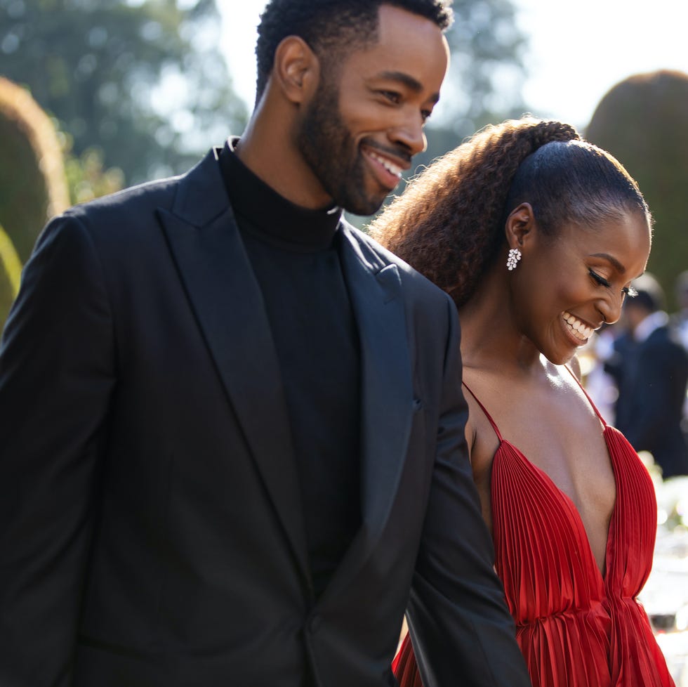 a couple dressed elegantly walking together outdoors a couple dressed elegantly walking together outdoors
