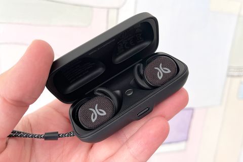 hand holding jaybird vista 2 earbuds in charging case