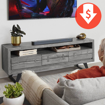a person sitting in a chair in front of a tv with a jbl bar 300 soundbar