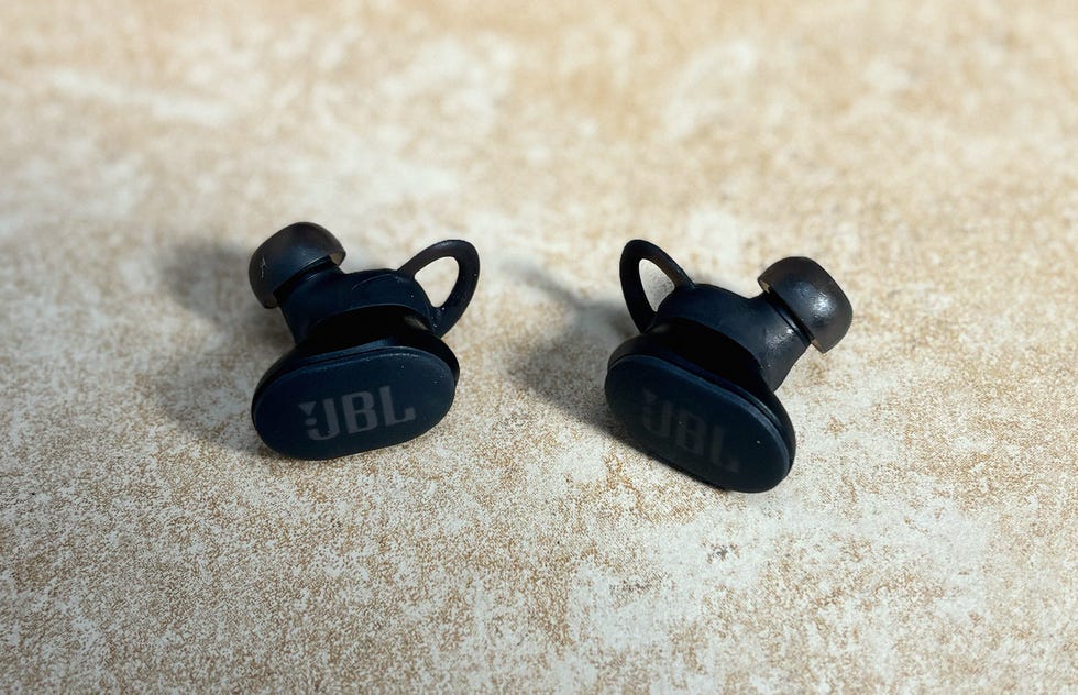 two black earbuds on a surface
