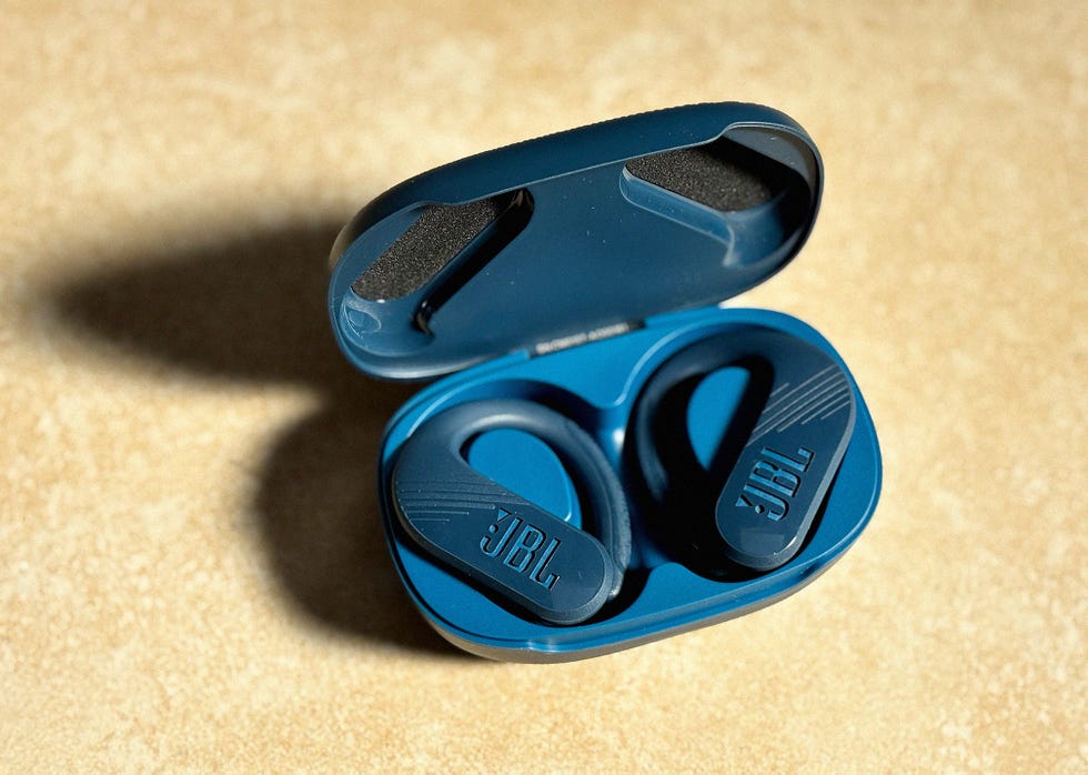 a pair of navy headphones in a charging case