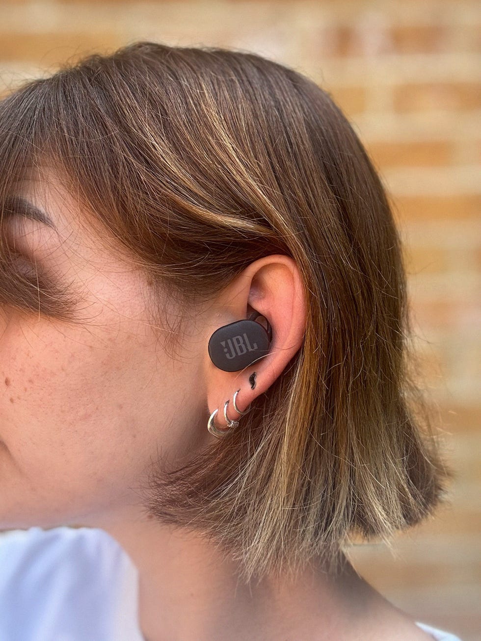 person wearing a black earbud