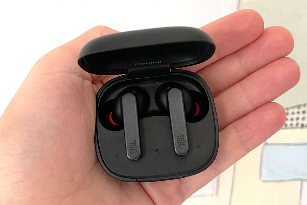 hand holding jbl live pro earbuds in case