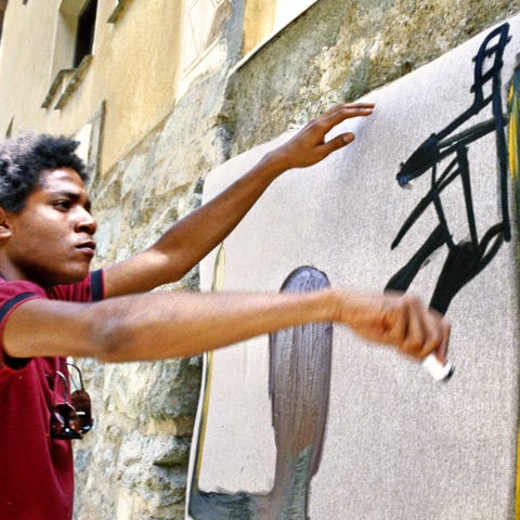 Jean-Michel Basquiat paints in 1983 in St. Moritz, Switzerland