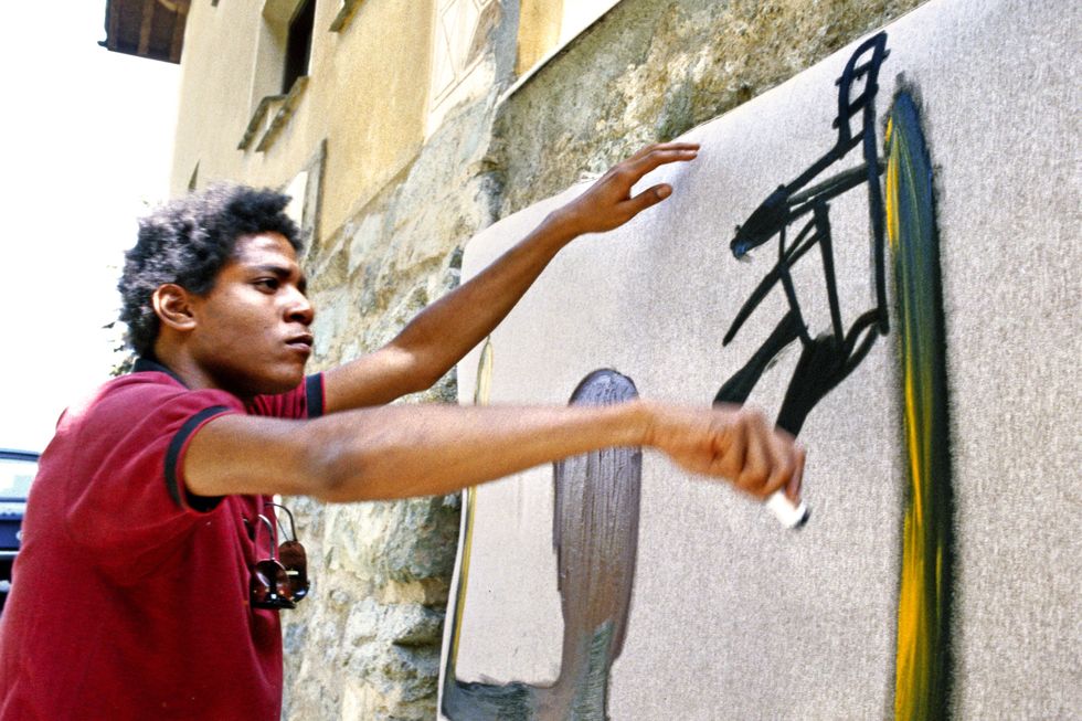 Jean-Michel Basquiat paints in 1983 in St. Moritz, Switzerland