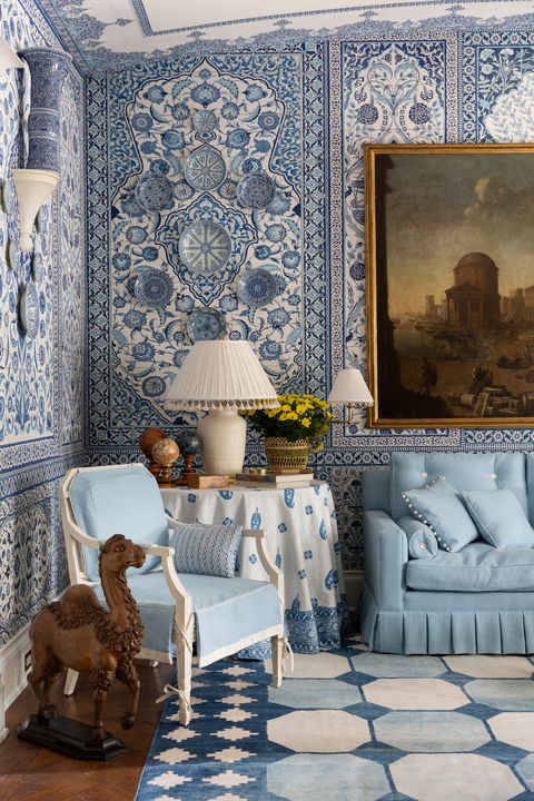blue and white printed living room blue and white wallpaper blue sofa blue armchair patterned rug