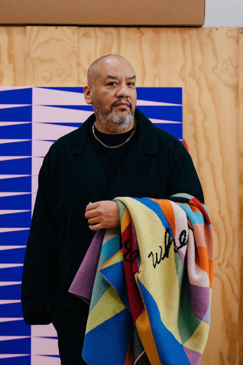 a man holding a colorful scarf