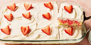 jello cake topped with frosting and strawberry slices