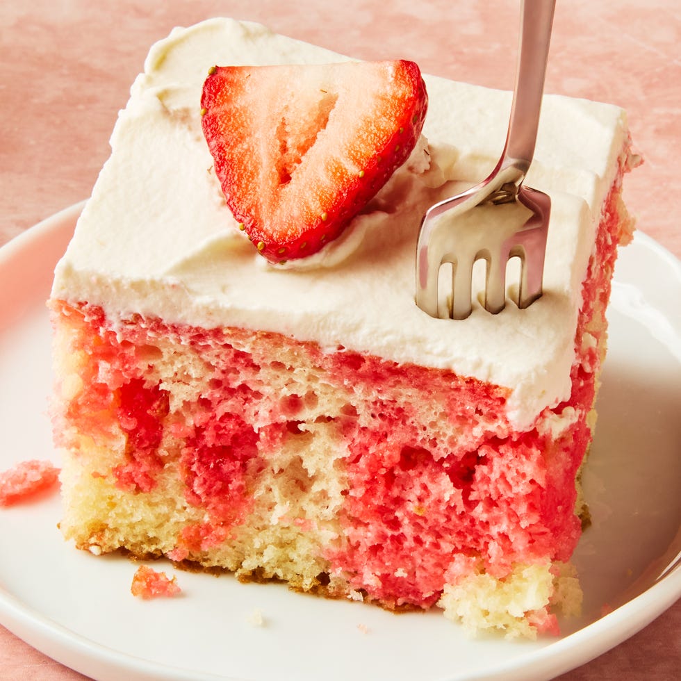 jello cake topped with frosting and strawberry slices