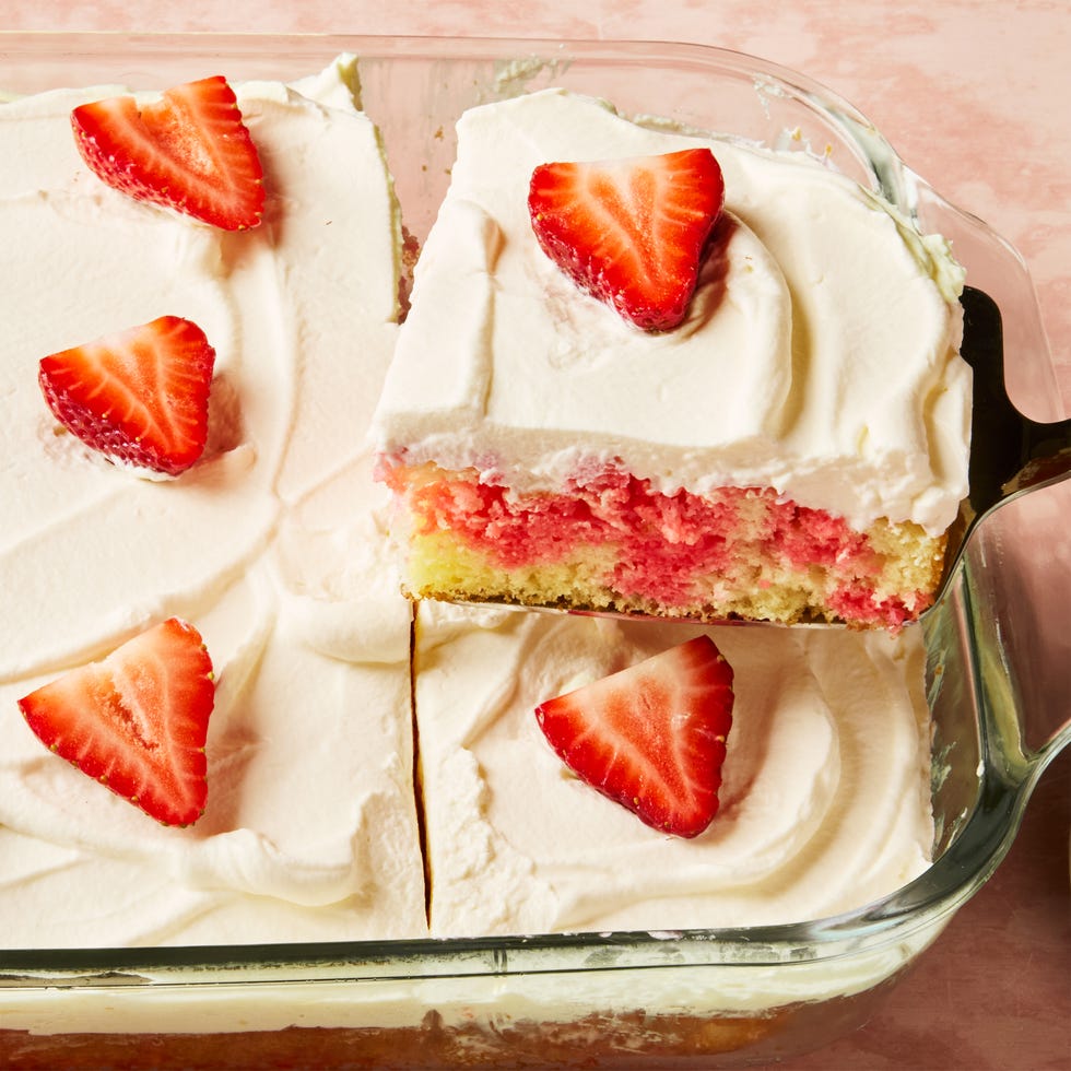 jello cake topped with frosting and strawberry slices