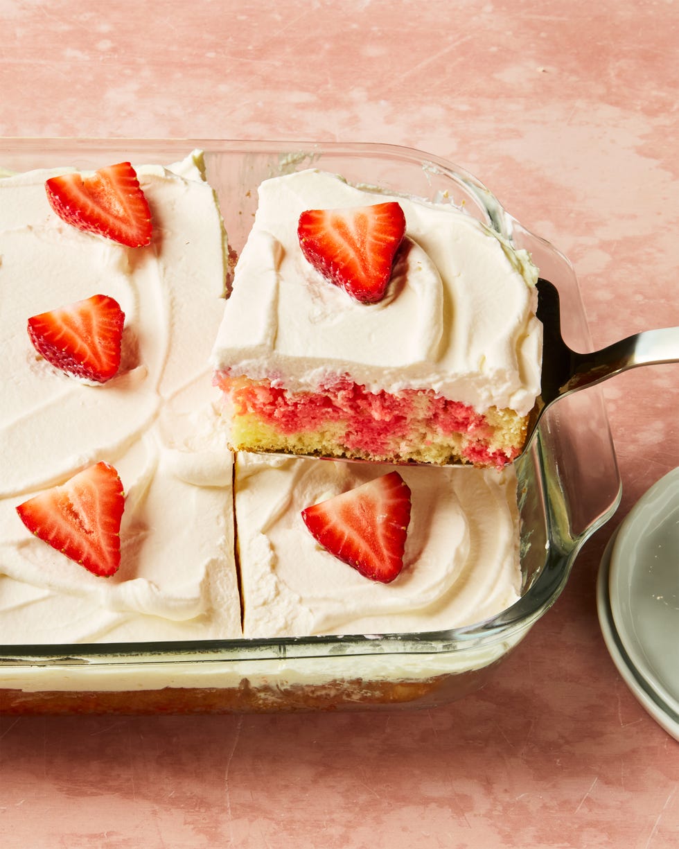 jello cake topped with frosting and strawberry slices