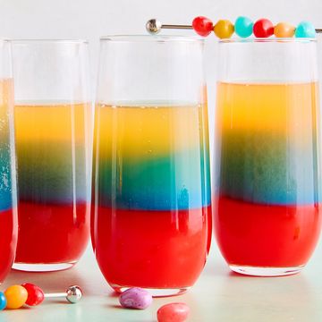 red, blue, and yellow layers in a drink topped with jelly beans