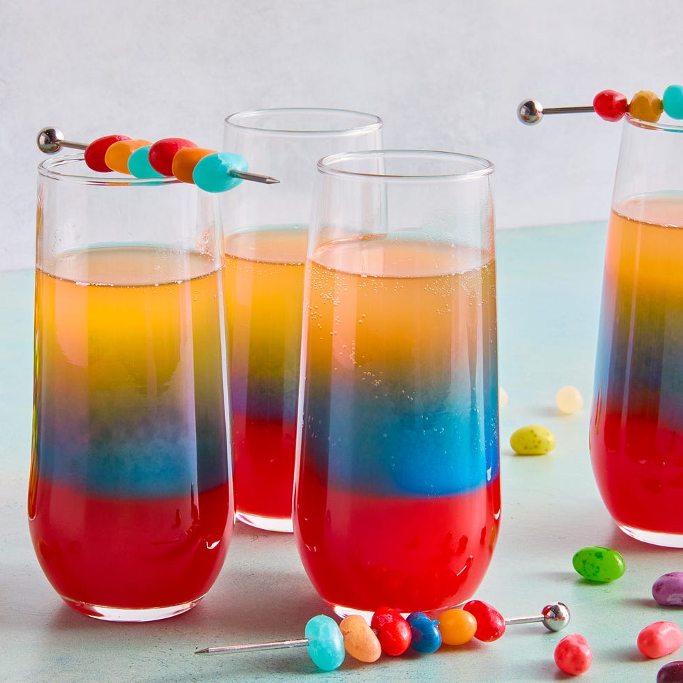 layered drink with red, blue, and orange topped with jelly beans