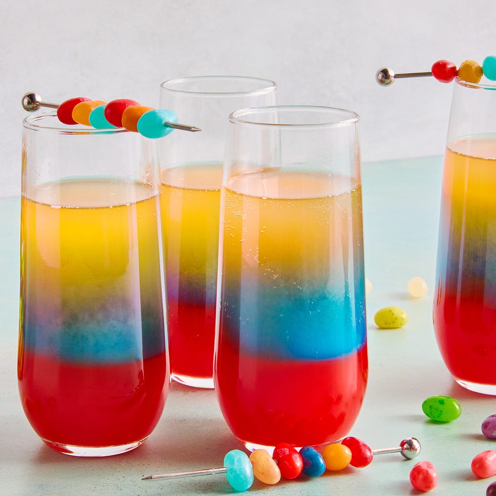 red, blue, and yellow layers in a drink topped with jelly beans