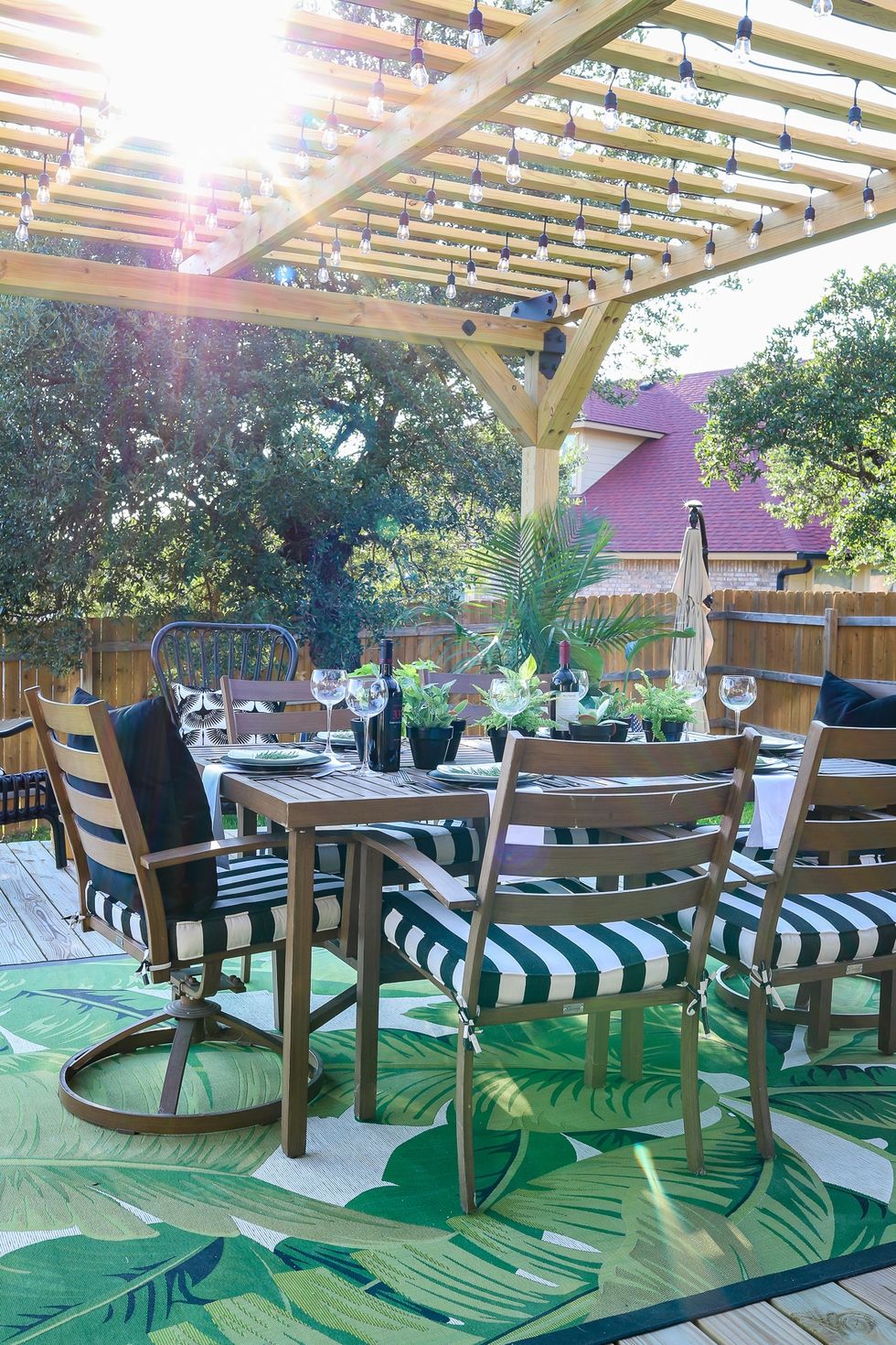 pergola with string lights over an outdoor patio