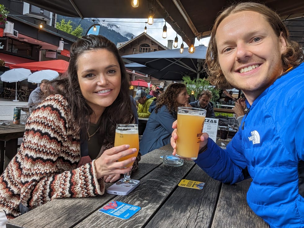 man and woman drink beer outside