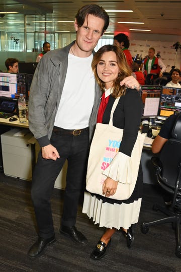 matt smith puts his arm around jenna coleman as they both smile for the camera