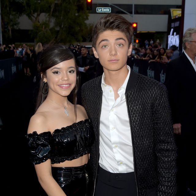 jenna ortega and asher angel posing on a red carpet together