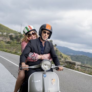 a man and woman riding a motorcycle