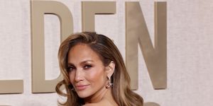 jennifer lopez on the golden globes red carpet with long curly hair