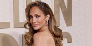 jennifer lopez on the golden globes red carpet with long curly hair