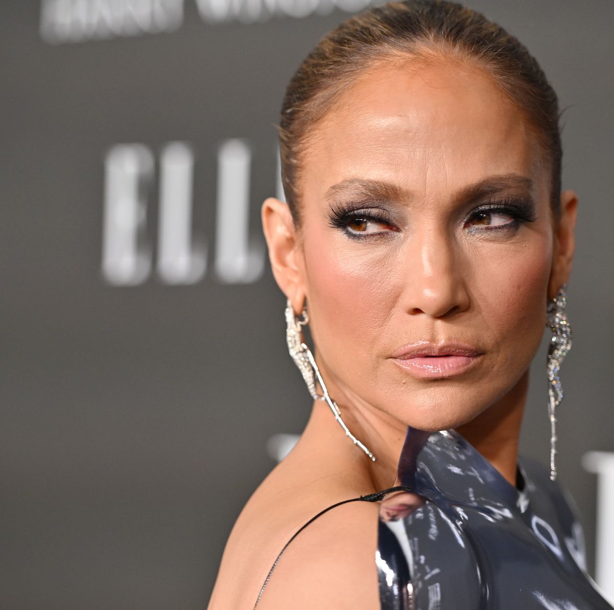 JLo wears a silver breastplate that flashes major underboob