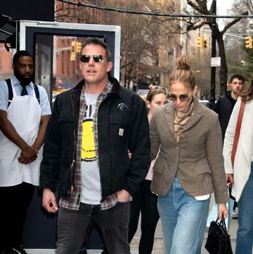 jennifer lopez and husband ben affleck walking through the streets of new york lopez is wearing a blazer jeans and heels affleck is wearing nike trainers and black jeans and jacket