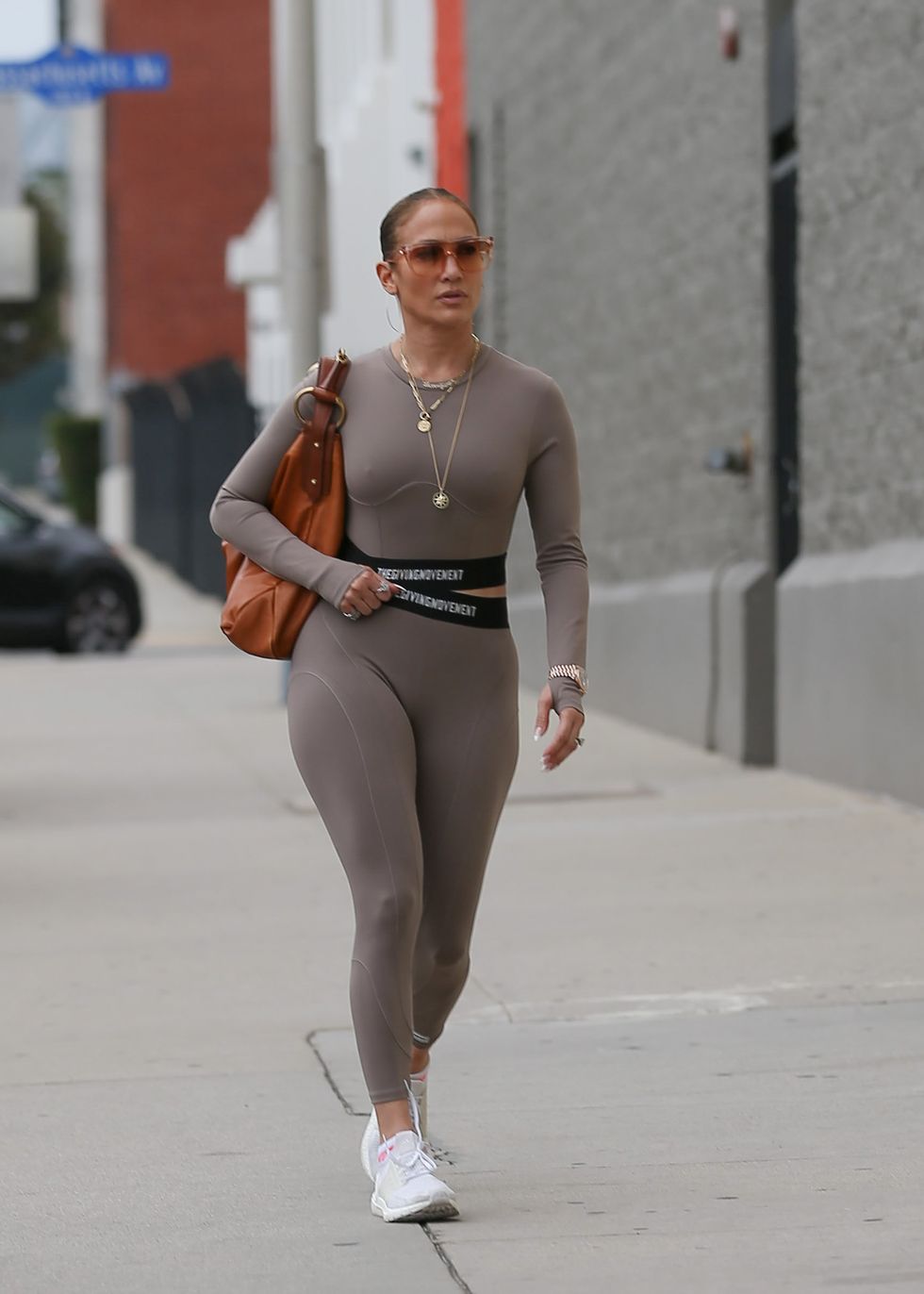 Jennifer Lopez sports a blue sweater and patterned leggings as she
