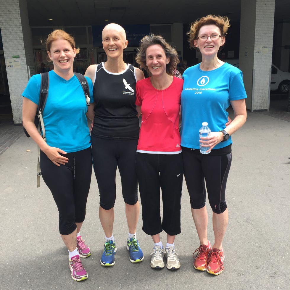 group of four women in athletic wear standing together outdoors