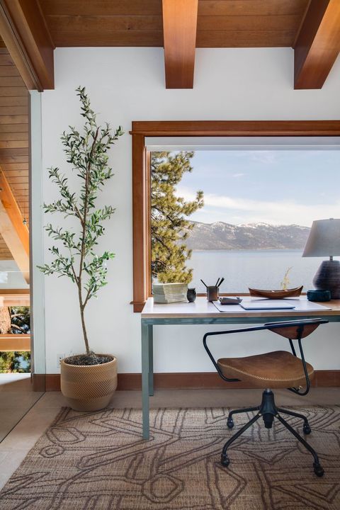 desk by open window with mountain view