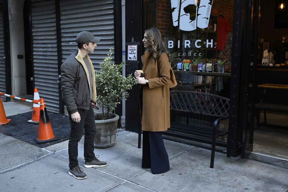 kendall and rava face off outside a coffee shop in a scene from the production of episode 407 of “succession”