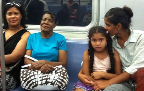 Jessica and her family riding the subway.