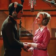 George and Tammy woman and man hold hands as they sing in a music studio